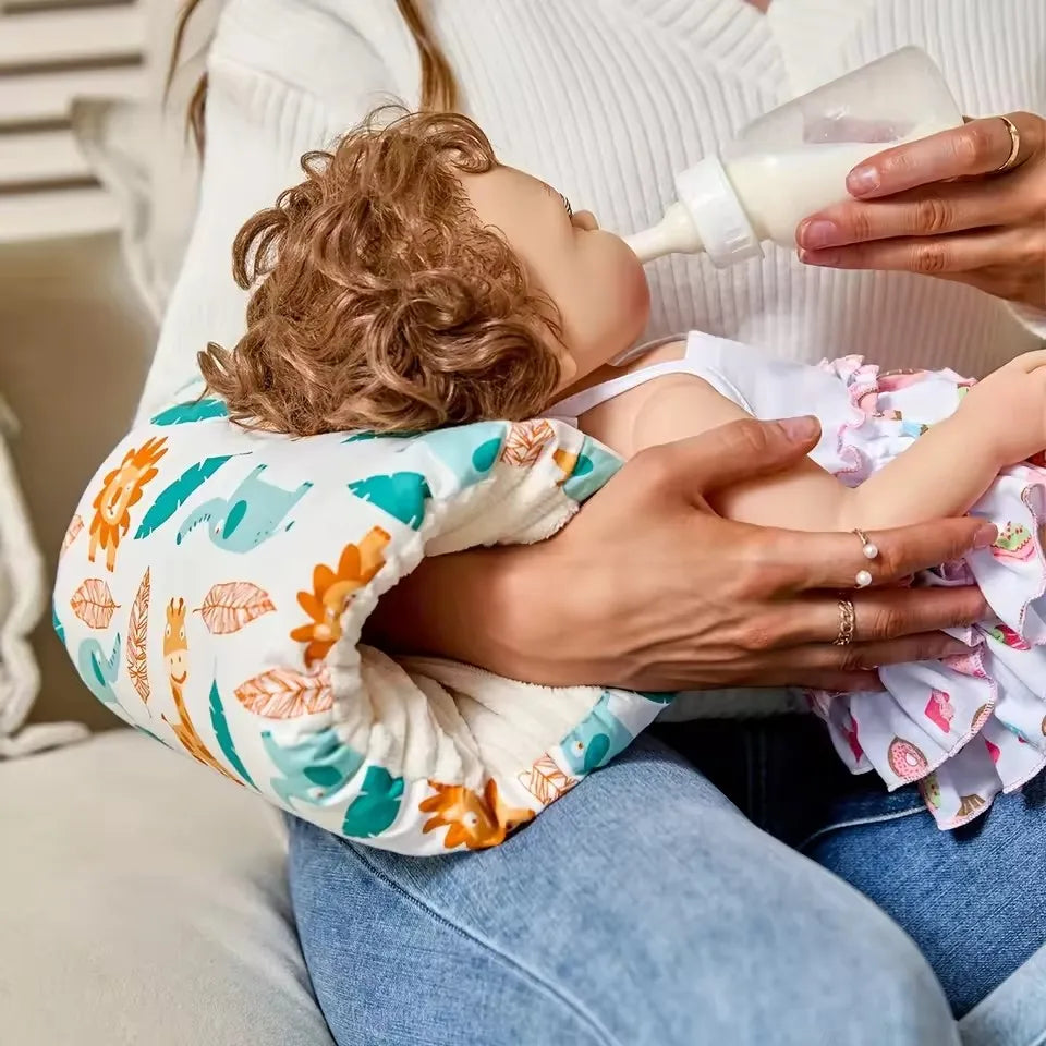 Woman bottle-feeding baby with animal print nursing pillow, baby essentials at Kid Zone