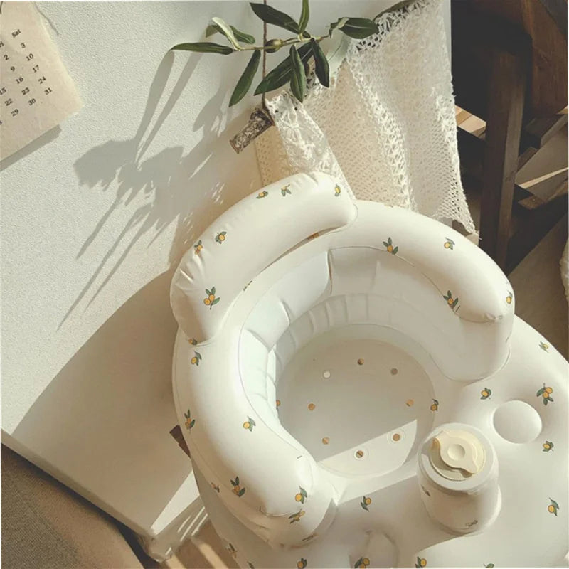 Inflatable baby seat with floral pattern in cozy nursery setting, ideal for comfort and play.