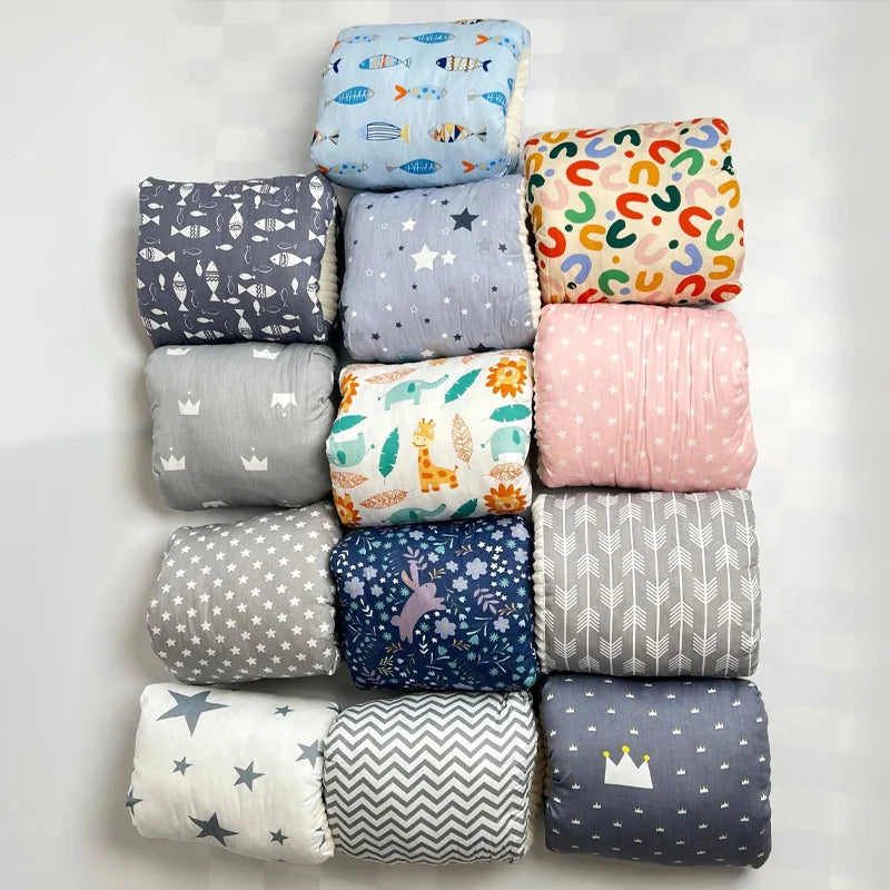 Assorted baby blankets with colorful patterns, stars, crowns, animals, and fish on display
