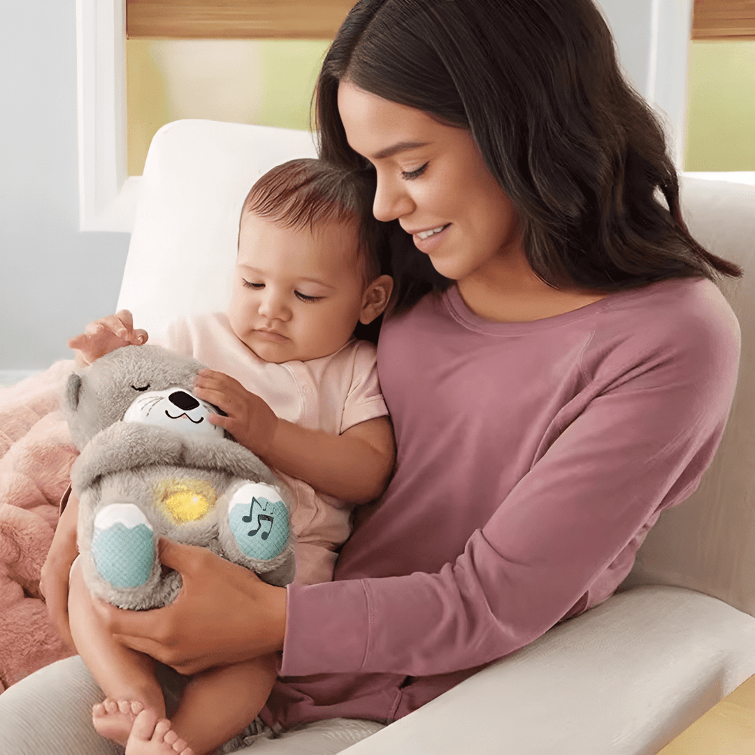 Mother and baby playing with a plush otter calming toy, baby essentials, educational toys